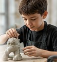A boy sculpting with clay