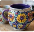 A hand-painted ceramic mug with sunflowers