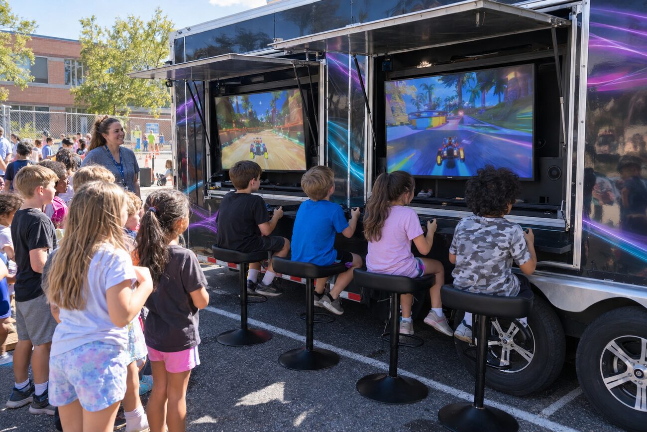 Kids playing on the exterior screens of the GameThrilla truck in a school parking lot