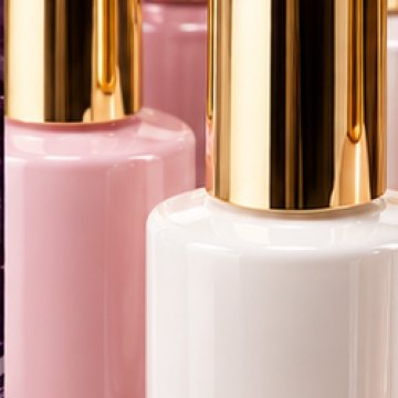 A group of gel polish bottles with gold caps