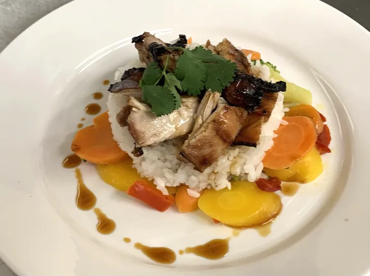 Roast chicken served with rice and vegetables