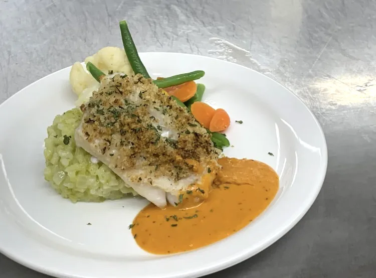 A plated main course with risotto